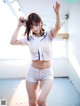 A woman in a baseball uniform is posing for a picture.